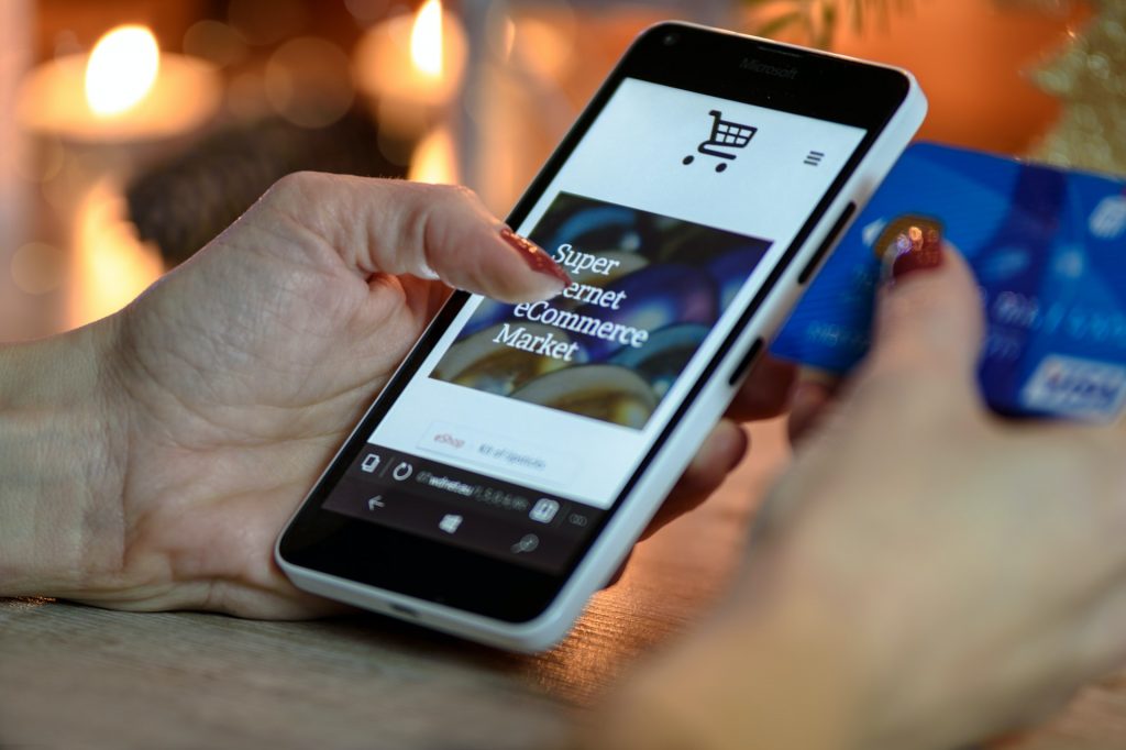 A shopper making a purchase from an eCommerce website using her smartphone. 