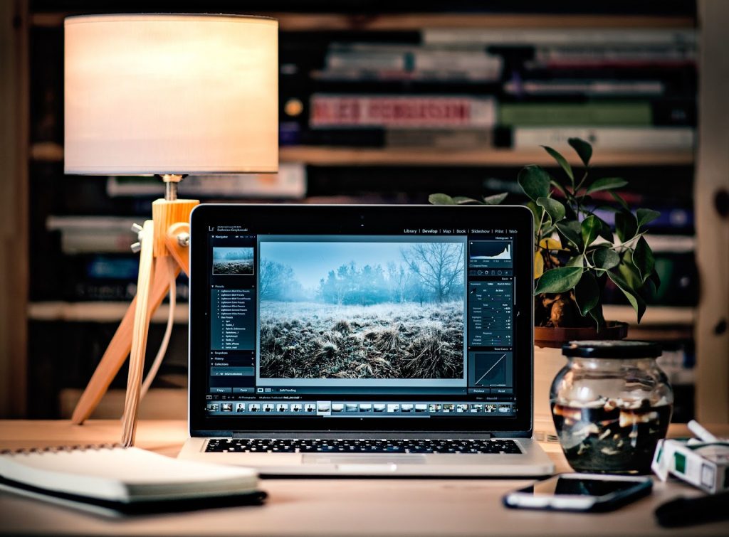 A desktop with a laptop displaying data.