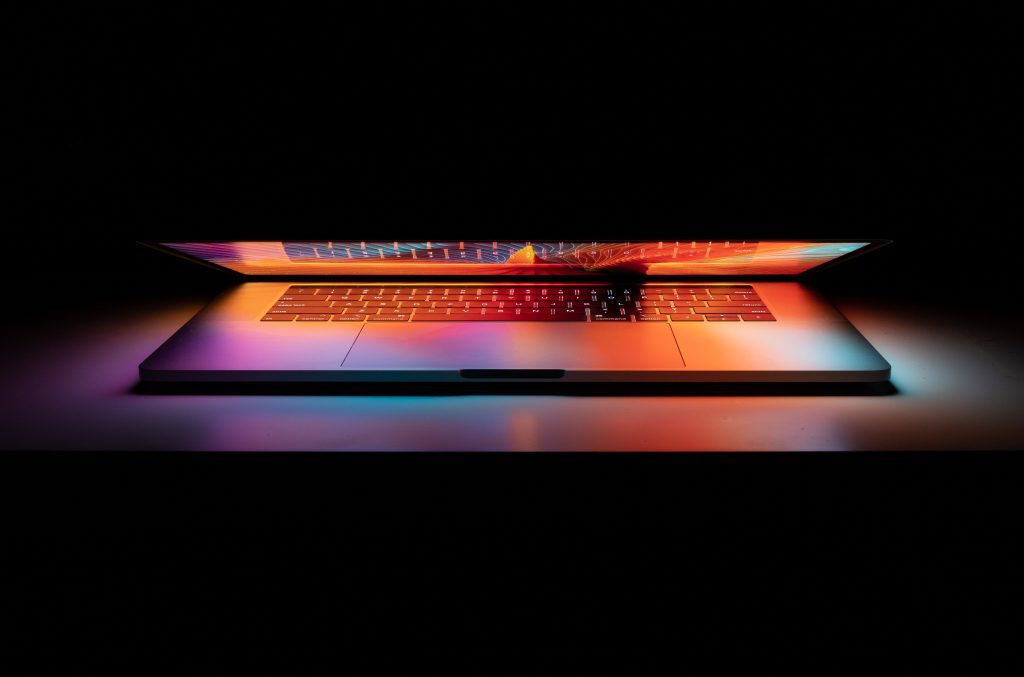 A laptop on  a desk. 